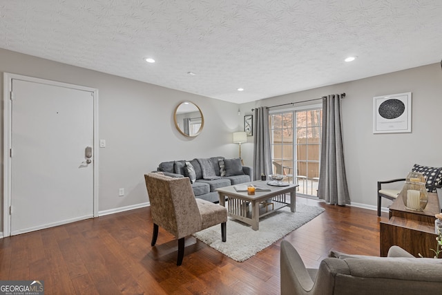 living room with dark hardwood / wood-style floors and a textured ceiling