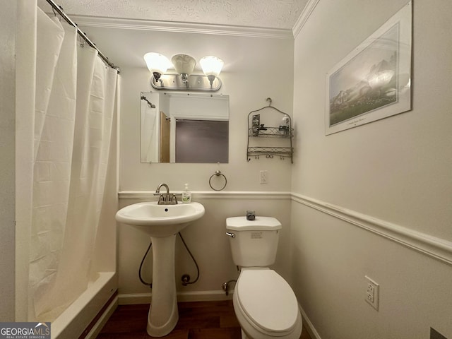 full bathroom with toilet, sink, a textured ceiling, ornamental molding, and hardwood / wood-style flooring