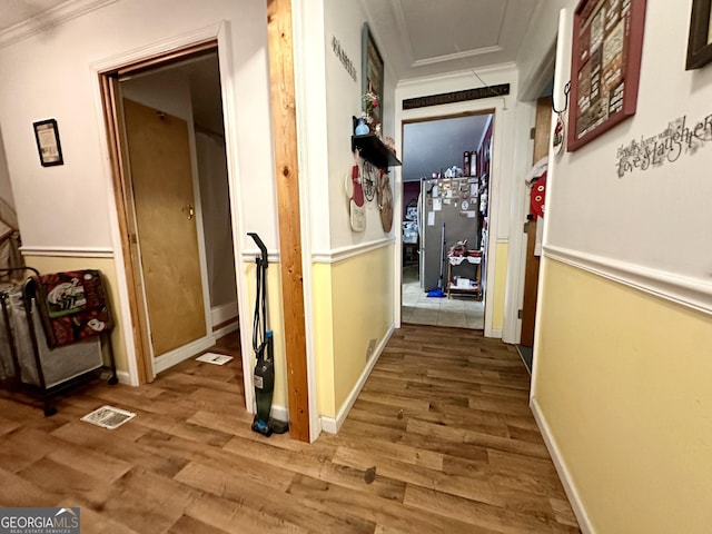 corridor featuring crown molding and wood-type flooring