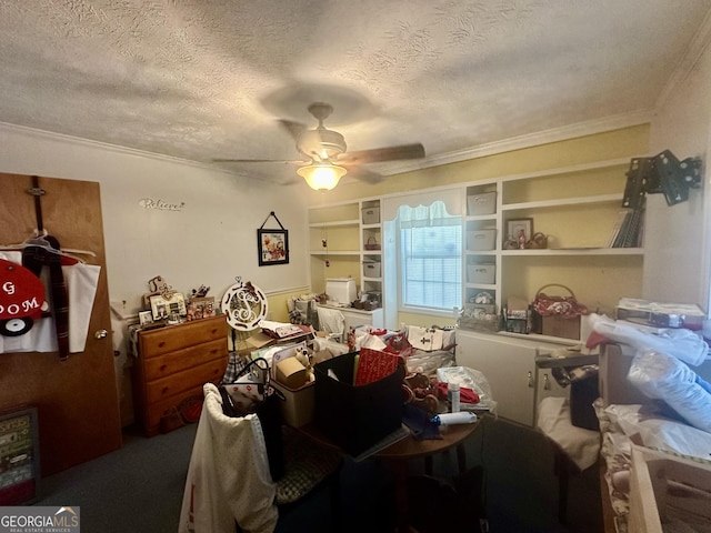 misc room with ceiling fan, ornamental molding, a textured ceiling, and built in shelves