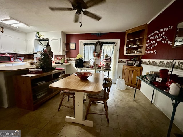 kitchen featuring dark tile patterned floors, white cabinets, ceiling fan, and decorative backsplash