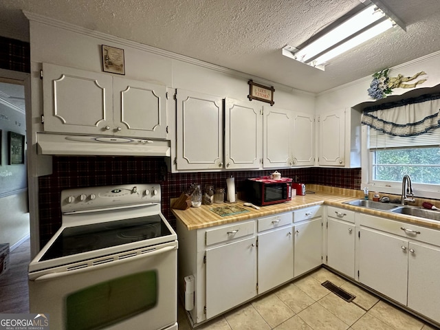 kitchen with electric stove, sink, backsplash, ornamental molding, and white cabinets