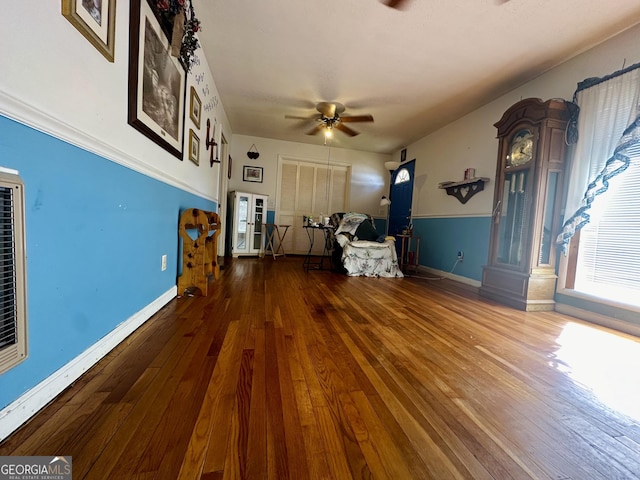 unfurnished living room featuring hardwood / wood-style flooring and ceiling fan