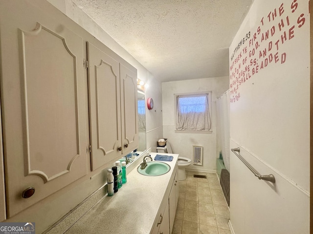 full bathroom featuring toilet, shower / tub combo, a textured ceiling, vanity, and tile patterned flooring