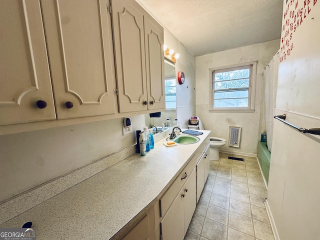 full bathroom with shower / tub combo with curtain, tile patterned floors, toilet, a textured ceiling, and vanity