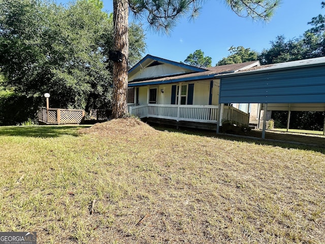 exterior space with a yard, a carport, and covered porch