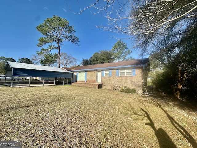 back of property featuring a carport and a yard