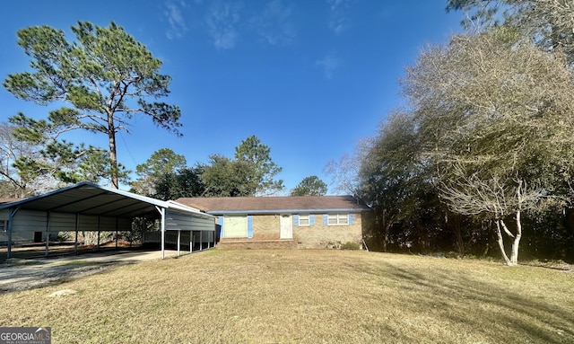 exterior space with a carport and a yard