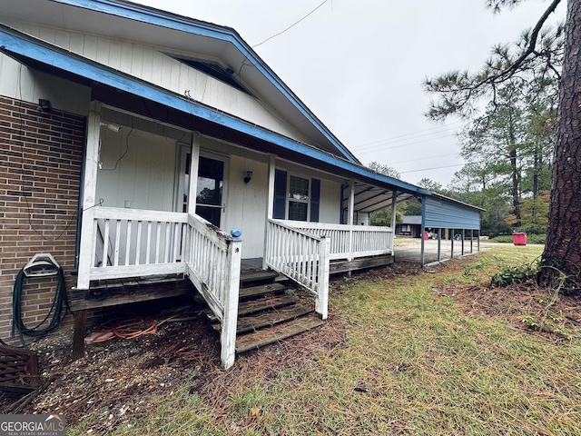 view of side of home featuring covered porch