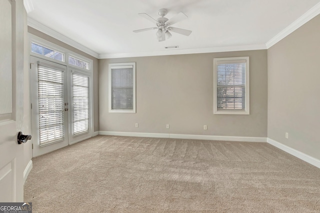 unfurnished room with light carpet, ornamental molding, french doors, and ceiling fan