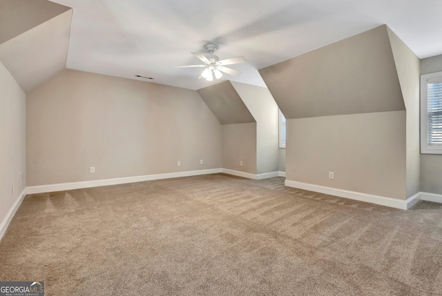 bonus room featuring lofted ceiling, carpet flooring, and ceiling fan