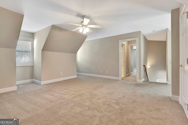 bonus room featuring vaulted ceiling, light colored carpet, and ceiling fan