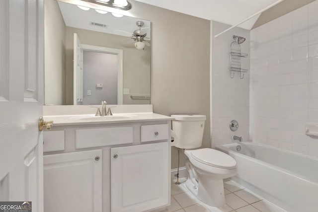 full bathroom featuring tiled shower / bath combo, vanity, ceiling fan, toilet, and tile patterned floors