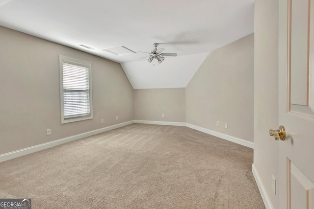 bonus room with ceiling fan, vaulted ceiling, and light carpet