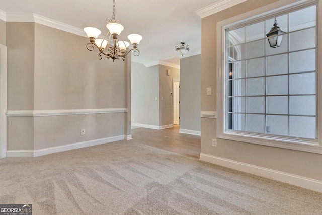 carpeted empty room with crown molding and a notable chandelier