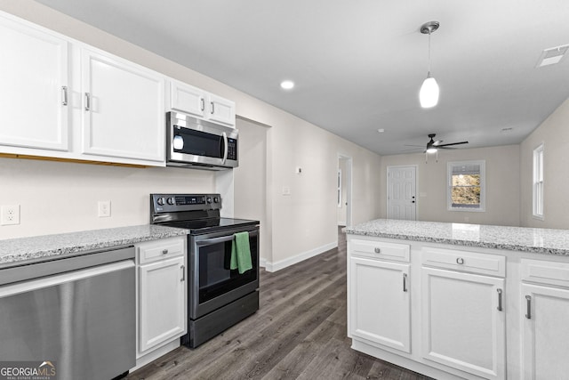 kitchen with stainless steel appliances, dark hardwood / wood-style floors, white cabinets, and decorative light fixtures