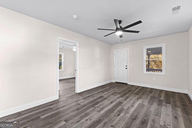 spare room featuring ceiling fan and dark hardwood / wood-style floors