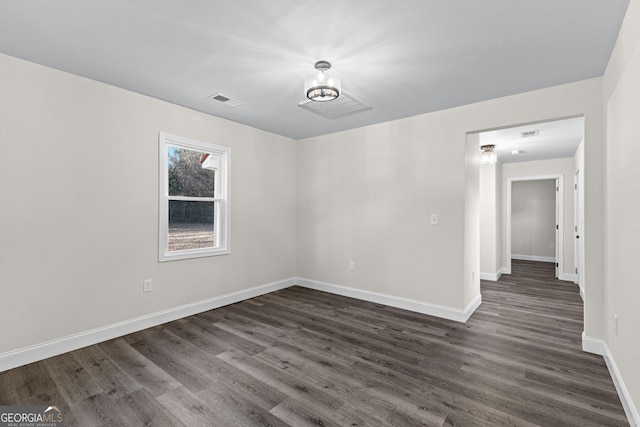 spare room featuring dark hardwood / wood-style floors