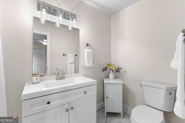 bathroom featuring vanity, ceiling fan, and toilet