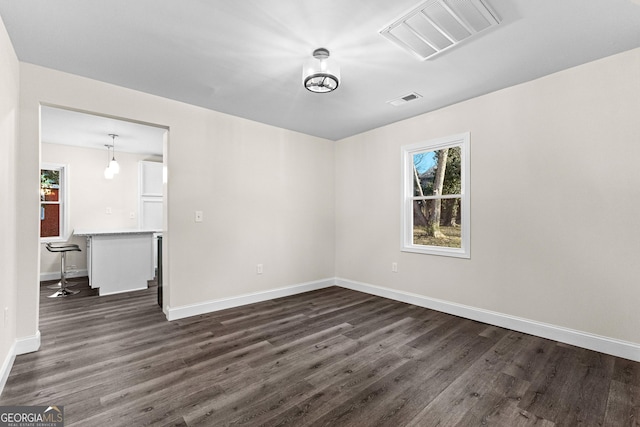 unfurnished room with dark hardwood / wood-style floors