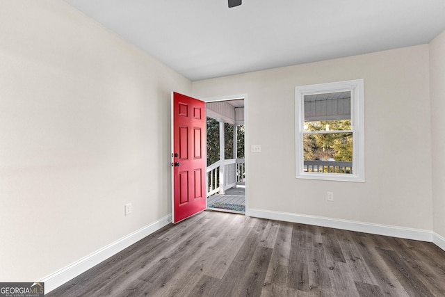 unfurnished room with dark hardwood / wood-style flooring