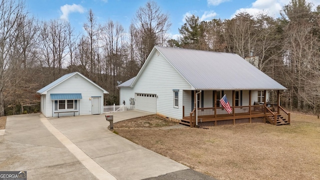 view of front of house featuring a garage, a front yard, and covered porch