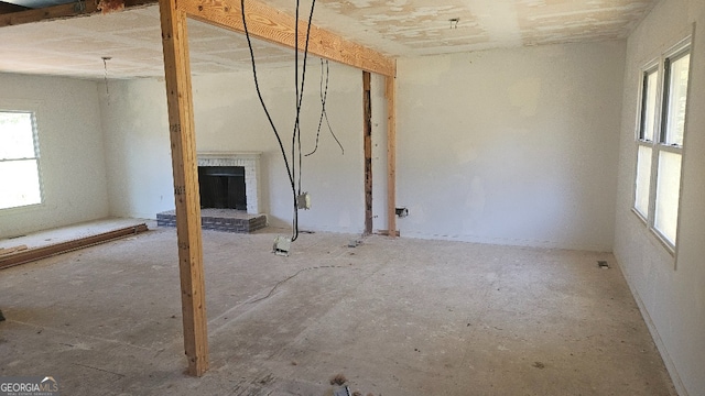 interior space with plenty of natural light and a brick fireplace