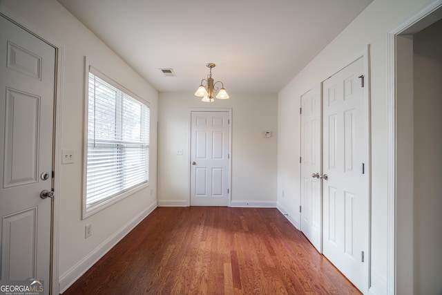 interior space with wood-type flooring and a notable chandelier