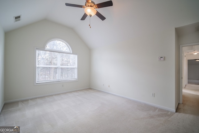 carpeted spare room with vaulted ceiling and ceiling fan