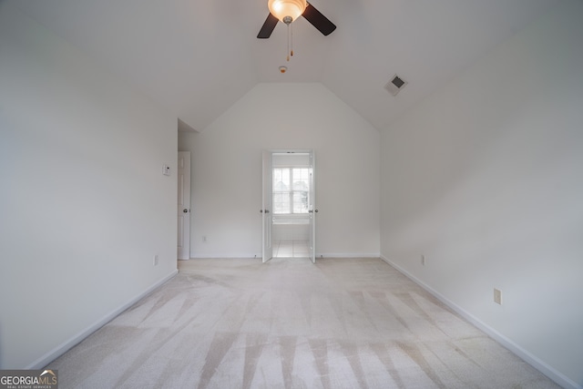 carpeted empty room featuring ceiling fan and vaulted ceiling