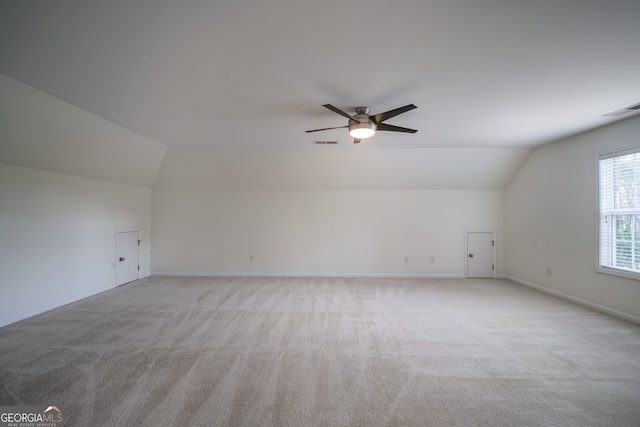 bonus room with ceiling fan, vaulted ceiling, and light carpet