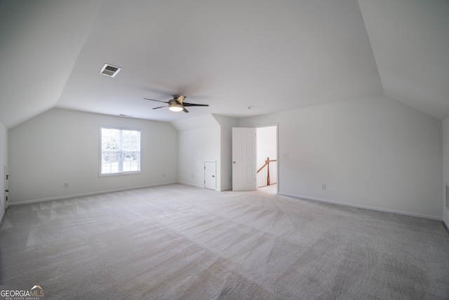 bonus room with ceiling fan, light colored carpet, and vaulted ceiling