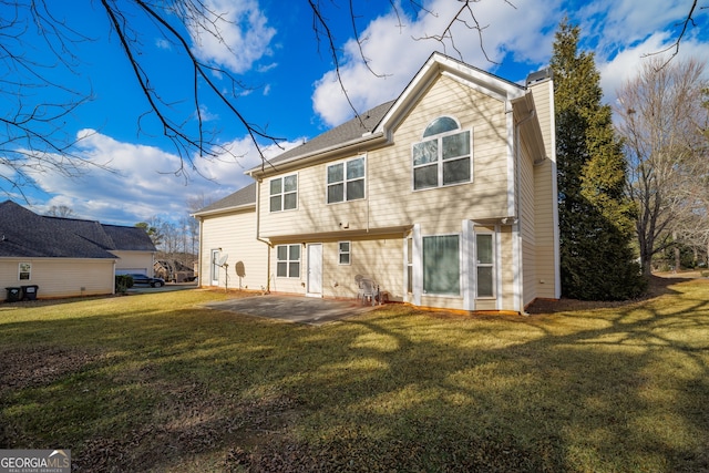 rear view of property with a patio and a lawn