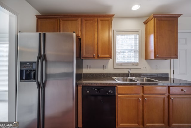 kitchen featuring dishwasher, sink, and stainless steel fridge