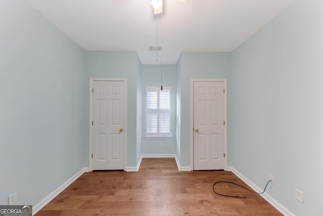 unfurnished room with wood-type flooring