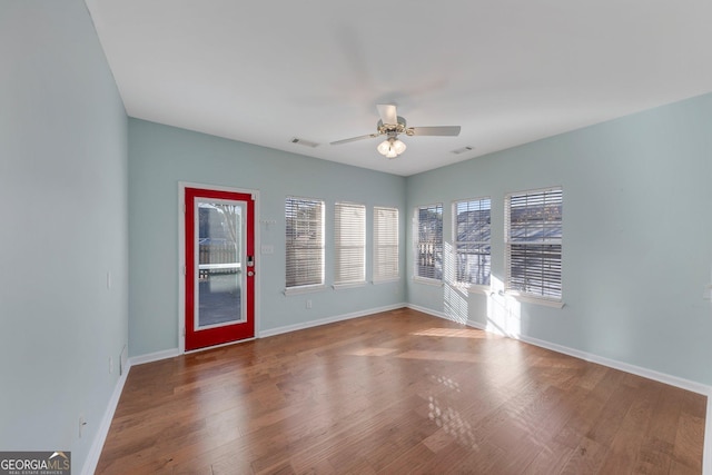 spare room featuring hardwood / wood-style flooring and ceiling fan