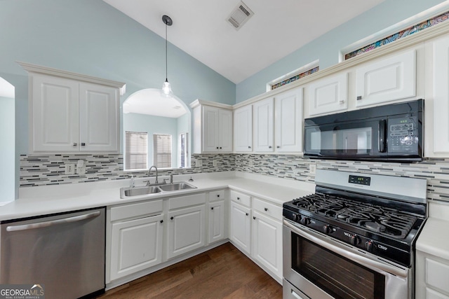 kitchen with vaulted ceiling, appliances with stainless steel finishes, dark hardwood / wood-style floors, pendant lighting, and sink