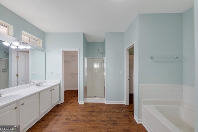 bathroom with hardwood / wood-style flooring, vanity, and separate shower and tub