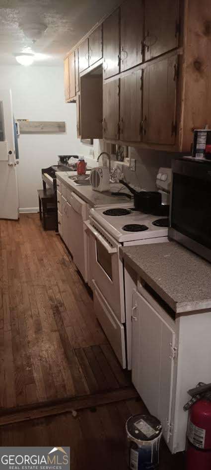 kitchen with white appliances and light hardwood / wood-style floors