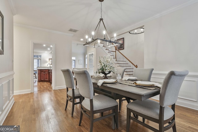 dining space featuring crown molding and wood-type flooring