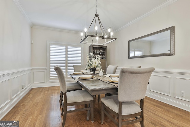 dining space with crown molding and hardwood / wood-style flooring