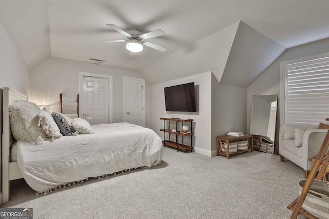 bedroom with lofted ceiling, light colored carpet, and ceiling fan