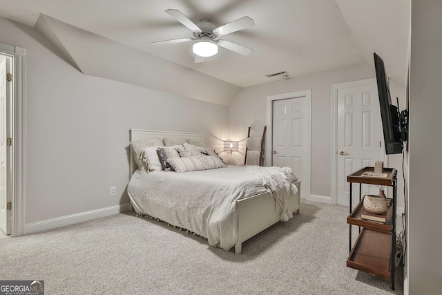 bedroom featuring ceiling fan, vaulted ceiling, and light carpet