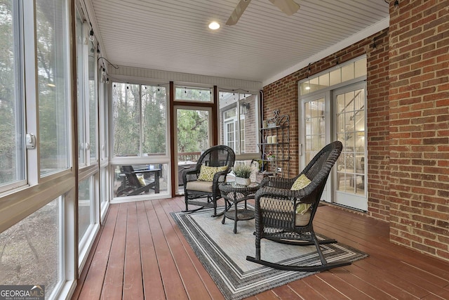 sunroom / solarium featuring ceiling fan