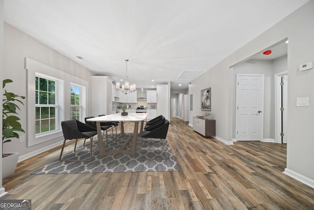 dining area with dark hardwood / wood-style floors and a chandelier