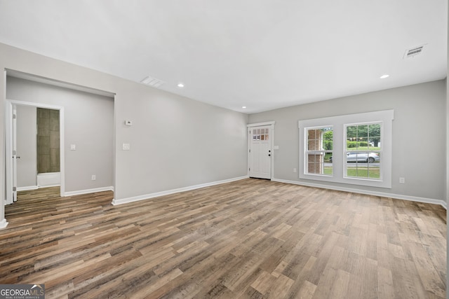 unfurnished living room featuring hardwood / wood-style flooring