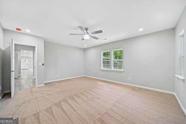 unfurnished bedroom featuring light colored carpet and ceiling fan