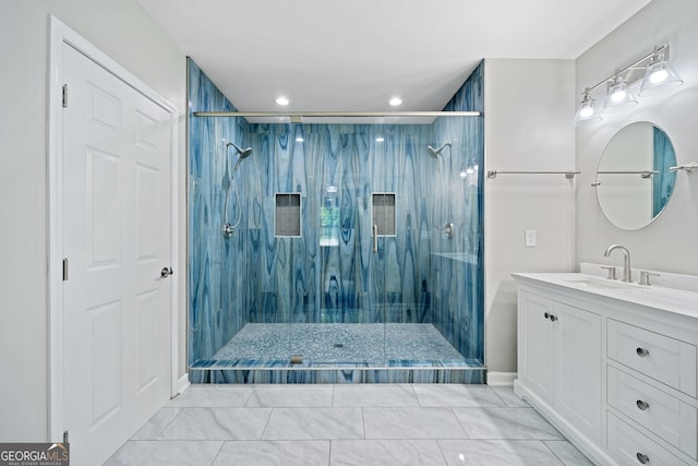 bathroom featuring tiled shower and vanity