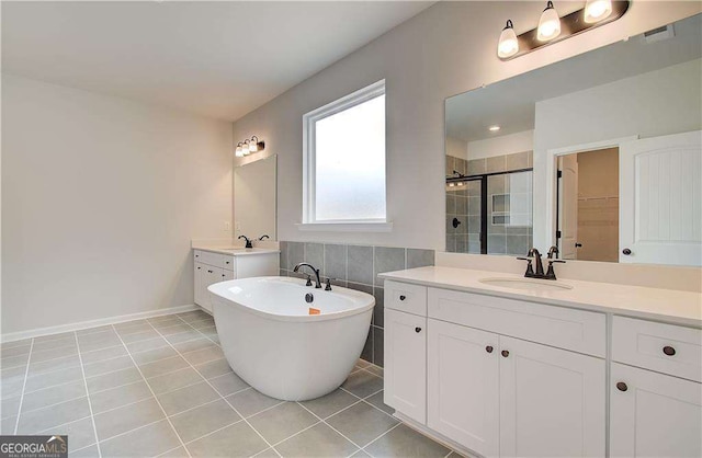 bathroom with tile patterned flooring, vanity, and independent shower and bath