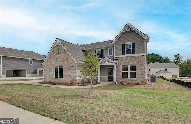 craftsman house featuring central AC unit and a front yard